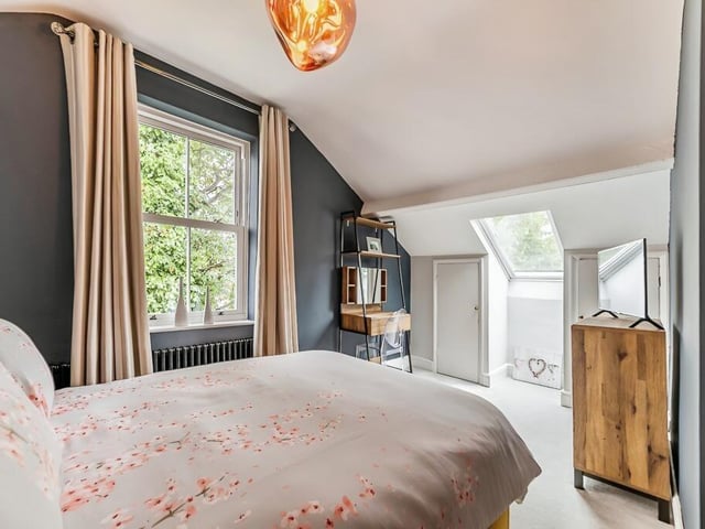 Natural light pours in to this bedroom through its large window, and an added skylight.