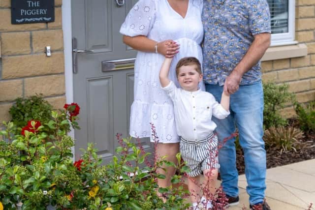 Lauren and Max Barber with their three-year-old son Charlie enjoying the garden of their new home