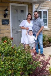 Lauren and Max Barber with their three-year-old son Charlie enjoying the garden of their new home