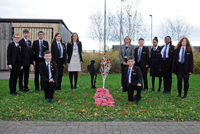 Katy Taylor-Clarke, Principal and Ann Peart, Principal PA, pictured with year 11 pupils by the Remembrance display at The Laurel Academy. Picture: NDFP-09-11-21-LaurelPoppies 1-NMSY