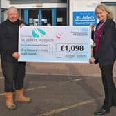 Roger handing over his latest donation to Lindsey Richards