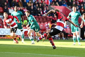 Doncaster Rovers' Joe Ironside scores a penalty past Sutton United's Dean Bouzanis.