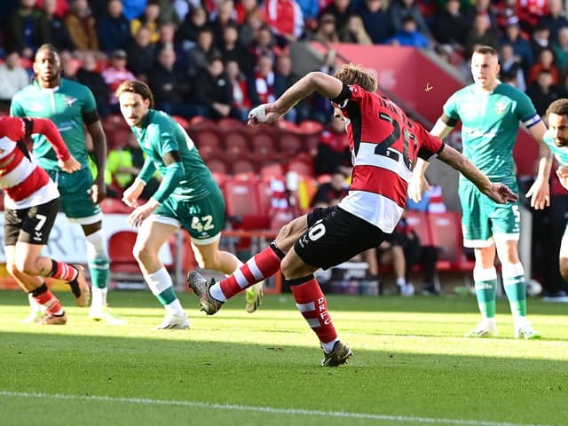 Doncaster Rovers' Joe Ironside scores a penalty past Sutton United's Dean Bouzanis.