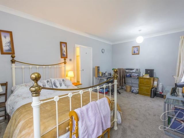 All four bedrooms are generously sized, including this one, which has a carpeted floor, a central heating radiator and  double windows.