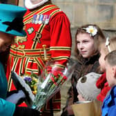 The Queen collects flowers from children outside Sheffield Cathedral for Maundy Thursday during a 2015 visit. Picture: Andrew Roe