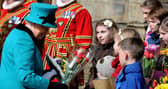 The Queen collects flowers from children outside Sheffield Cathedral for Maundy Thursday during a 2015 visit. Picture: Andrew Roe