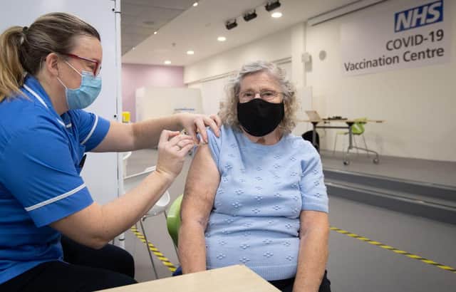 Margaret Austin, 87, on her first time out in six months, receives an injection of a Covid-19 vaccine at a mass vaccination hub (Photo by Joe Giddens / POOL / AFP)