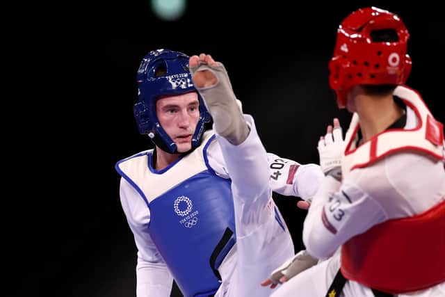 Bradly Sinden (L) of Team Great Britain competes against Zhao Shuai of Team China during the Men's -68kg Taekwondo Semifinal contest on day two of the Tokyo 2020 Olympic Games at Makuhari Messe Hall on July 25, 2021 in Chiba, Japan (photo by Maja Hitij/Getty Images)