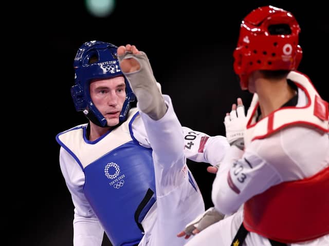 Bradly Sinden (L) of Team Great Britain competes against Zhao Shuai of Team China during the Men's -68kg Taekwondo Semifinal contest on day two of the Tokyo 2020 Olympic Games at Makuhari Messe Hall on July 25, 2021 in Chiba, Japan (photo by Maja Hitij/Getty Images)