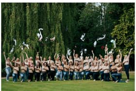 Dozens of women ditched their bras for the cheeky fundraising snap.