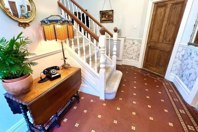The welcoming hallway with tiled floor sets the stylish tone.