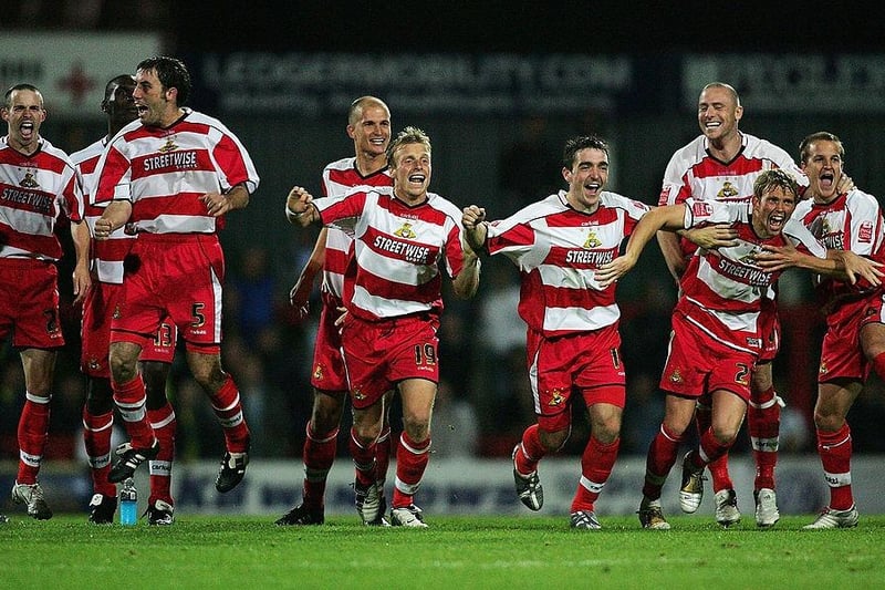 Doncaster Rovers' players celebrate their penalty shoot-out victory in the Carling Cup against Manchester City at Belle Vue on September 21, 2005.