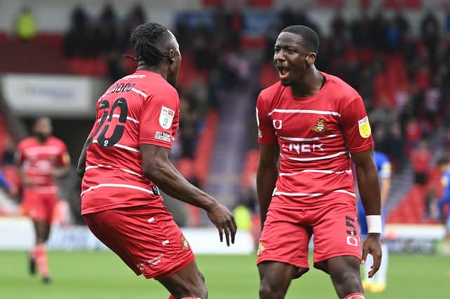 Joe Dodoo celebrates his goal against Cheltenham with Joseph Olowu. Photo: Howard Roe/AHPIX LTD