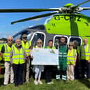 Handing over the proceeds to the Children's Air Ambulance.