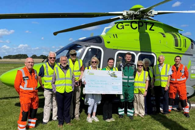 Handing over the proceeds to the Children's Air Ambulance.