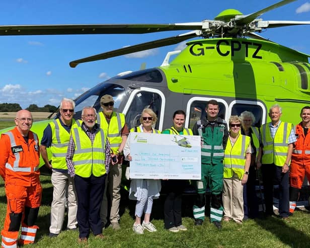 Handing over the proceeds to the Children's Air Ambulance.