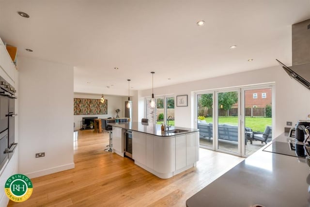 The large, open plan living kitchen has bi-fold doors to outside.