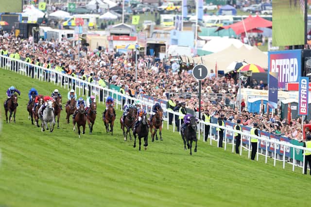 Auguste Rodin, ridden by Ryan Moore, sweeps to victory in last year's Betfred Derby at Epsom Downs, collaring the leader King Of Steel, who finished second. (PHOTO BY: Warren Little/Getty Images)