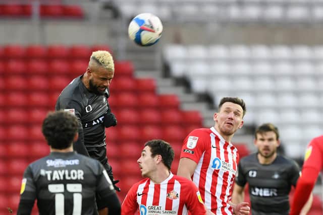 John Bostock heads clear after coming off the bench against Sunderland. Picture: Howard Roe/AHPIX