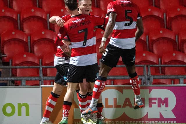 DECISIVE MOMENT: Owen Bailey celebrates with team-mates Joseph Olowu and Luke Molyneux after scoring what proved to be Doncaster Rovers' winning goal against Wrexham on Tuesday night, pushing them closer to play-off contention. Picture: Bruce Rollinson