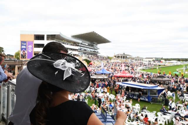 Spectators watch the racing during ladies day of the St Leger Festival at Doncaster Racecourse on September 12, 2019. Photo by George Wood/Getty Images