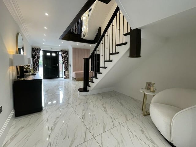 A gleaming entrance hallway has space for seating.