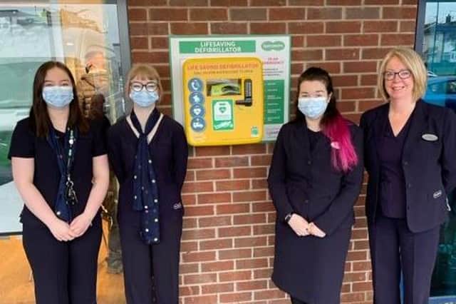 Staff at Specsavers Armthorpe branch pictured with the life saving defibrillator