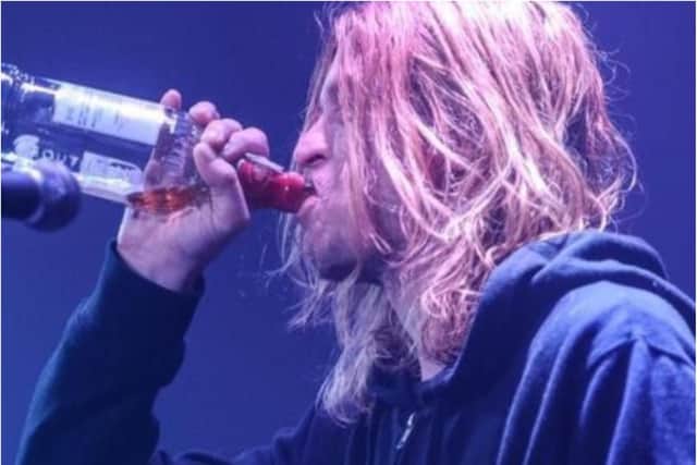Puddle of Mudd's Wes Scantlin swings from a bottle during a chaotic Doncaster gig in 2016. (Photo: Robin Burns).
