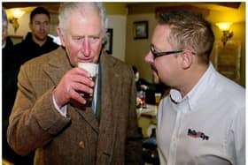 The then Prince Charles enjoys a drink at the Hare and Hounds in Fishlake in 2019.