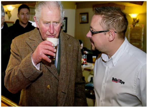 The then Prince Charles enjoys a drink at the Hare and Hounds in Fishlake in 2019.