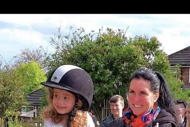 A youngster takes a ride on a unicorn