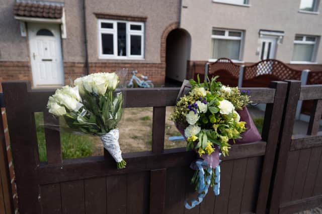 Floral tributes outside the house where a 12-day-old baby was mauled to death by a dog. Picture: Tom Maddick/SWNS.