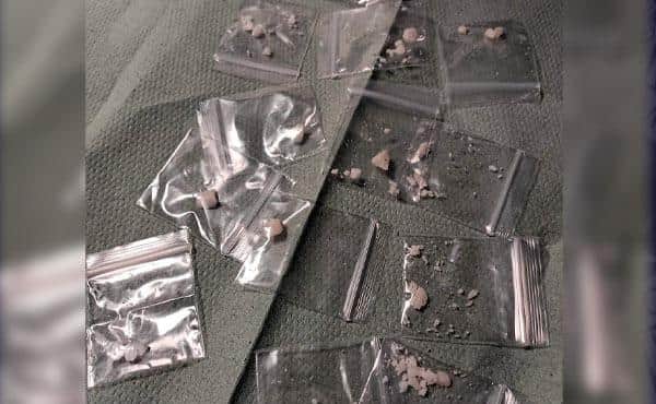 Suspicious bulge in woman's shorts leads to arrests and drugs seizures after police stop.