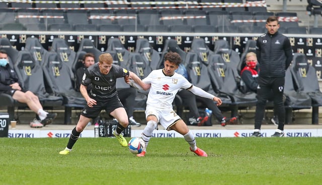 Brad Halliday tussles with MK Dons' Matthew Sorinola as Andy Butler looks on. Picture: Gareth Williams/AHPIX