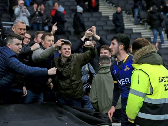 Doncaster Rovers defender Danny Amos celebrates with the fans