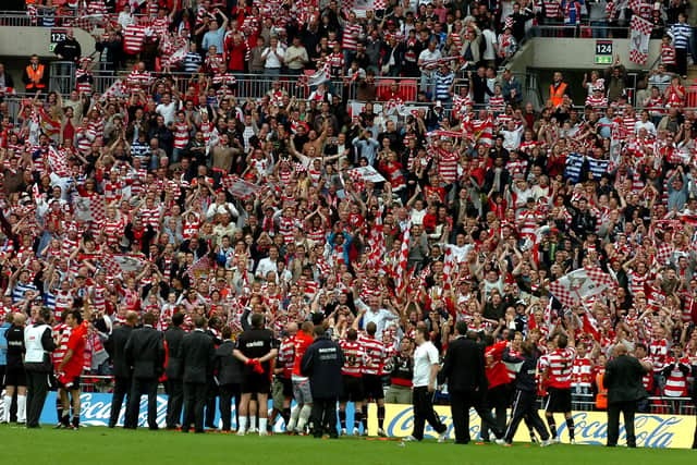 Rovers players celebrate in front of their supporters at Wembley