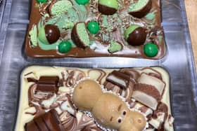 Chocolate slabs are topped with a variety of sweets and chocolate.