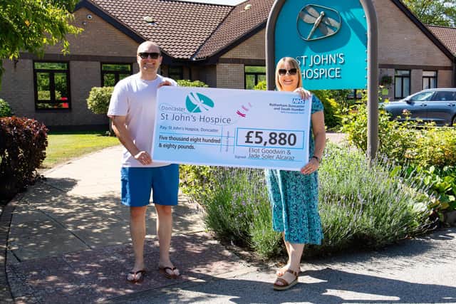 Eliot Goodwin (left) and Jade Soler Alcaraz (right) are pictured presenting their cheque at St John’s Hospice.