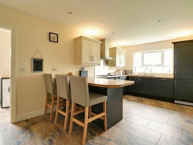 A bright and modern kitchen with breakfast bar.