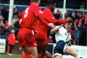 A young David Beckham in action against Doncaster Rovers in 1995.