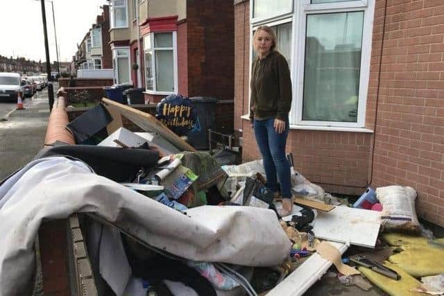 A woman surveys the damaged contents of her house on Hunt Lane, Bentley, following flooding in 2019. Credit: George Torr/LDRS