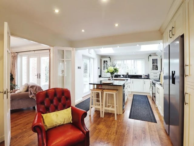 An alternative view of the kitchen with its central island and breakfast bar.