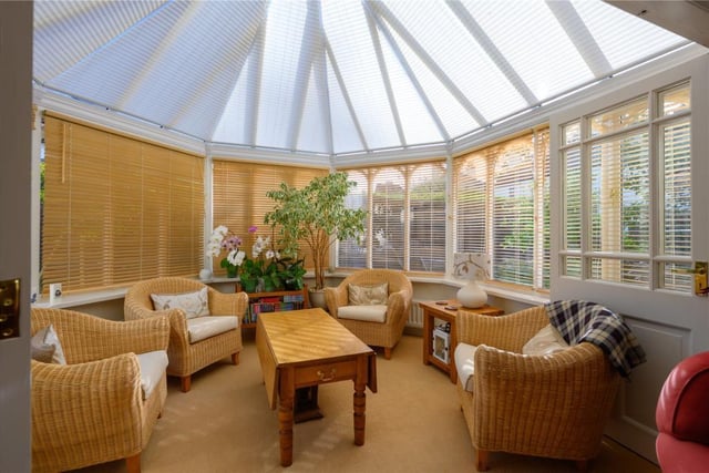 The conservatory has window and ceiling blinds and a door to the terrace.