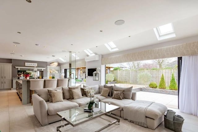 Relaxed space as part of the open plan living kitchen has bi-folding doors to seating areas outside.