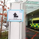 A sign directs patients towards an NHS 111 Coronavirus Pod (Photo by ISABEL INFANTES/AFP via Getty Images)