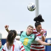 Doncaster Belles' captain Jess Andrew wins a header against Merseyrail Ladies.