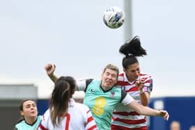 Doncaster Belles' captain Jess Andrew wins a header against Merseyrail Ladies.