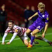Luke Molyneux is pushed off the ball by Saxon Earley.