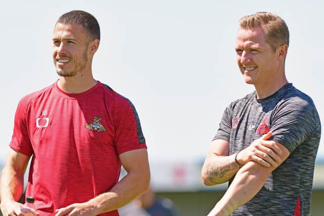 Doncaster Rovers boss Gary McSheffrey with midfielder Tommy Rowe. Photo: Andrew Roe/AHPIX LTD.