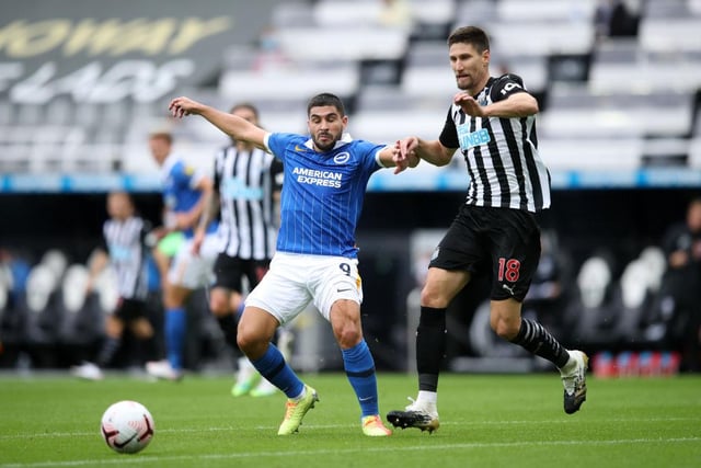 Neal Maupay of Brighton and Hove Albion is challenged by Federico Fernandez of Newcastle United.